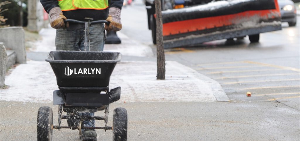 A worker taking care of concrete surfaces during the winter.