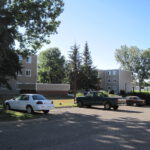 Cars in the parking lot at a residential property managed by Larlyn.