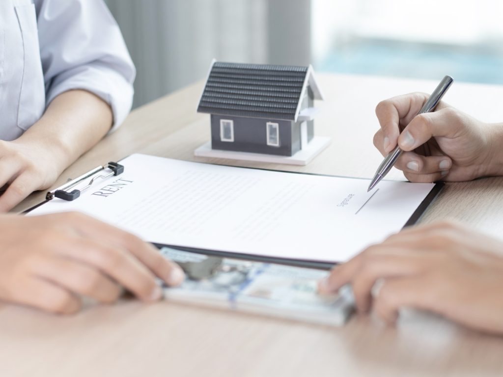 Landlord and tenant going over legal requirements for a rental agreement in Alberta.