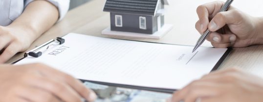 Landlord and tenant going over legal requirements for a rental agreement in Alberta.