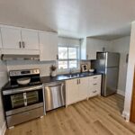 kitchen with stainless steel fridge, stove, and dishwasher in 3-bedroom townhome for rent in Brantford, ON