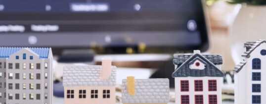 Miniature Property Models for Real Estate Comparison, Showing the Shift from Condos to Rentals